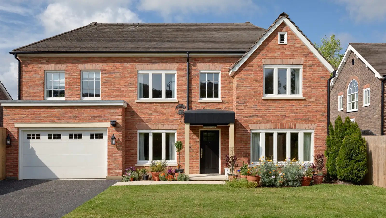 White uPVC casement windows on a red-brick UK semi